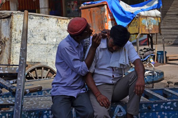Life in Delhi - finding something to do is both easy and difficult. An ear-cleaning expert on the roadside