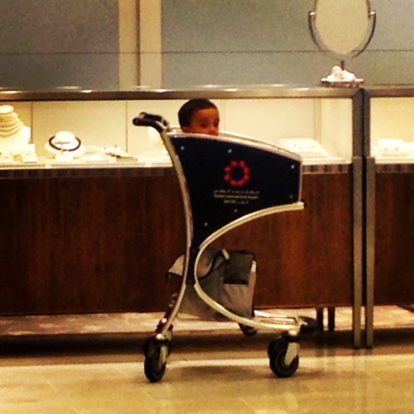 A baby in an airport trolley... in Hamad