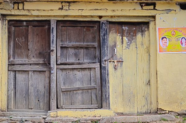 Even closed doors have stories to share as you walk along an empty mountain road 