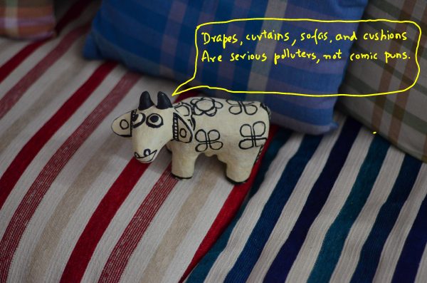 The moo-rap of an artsy cow_on upholstery in the house